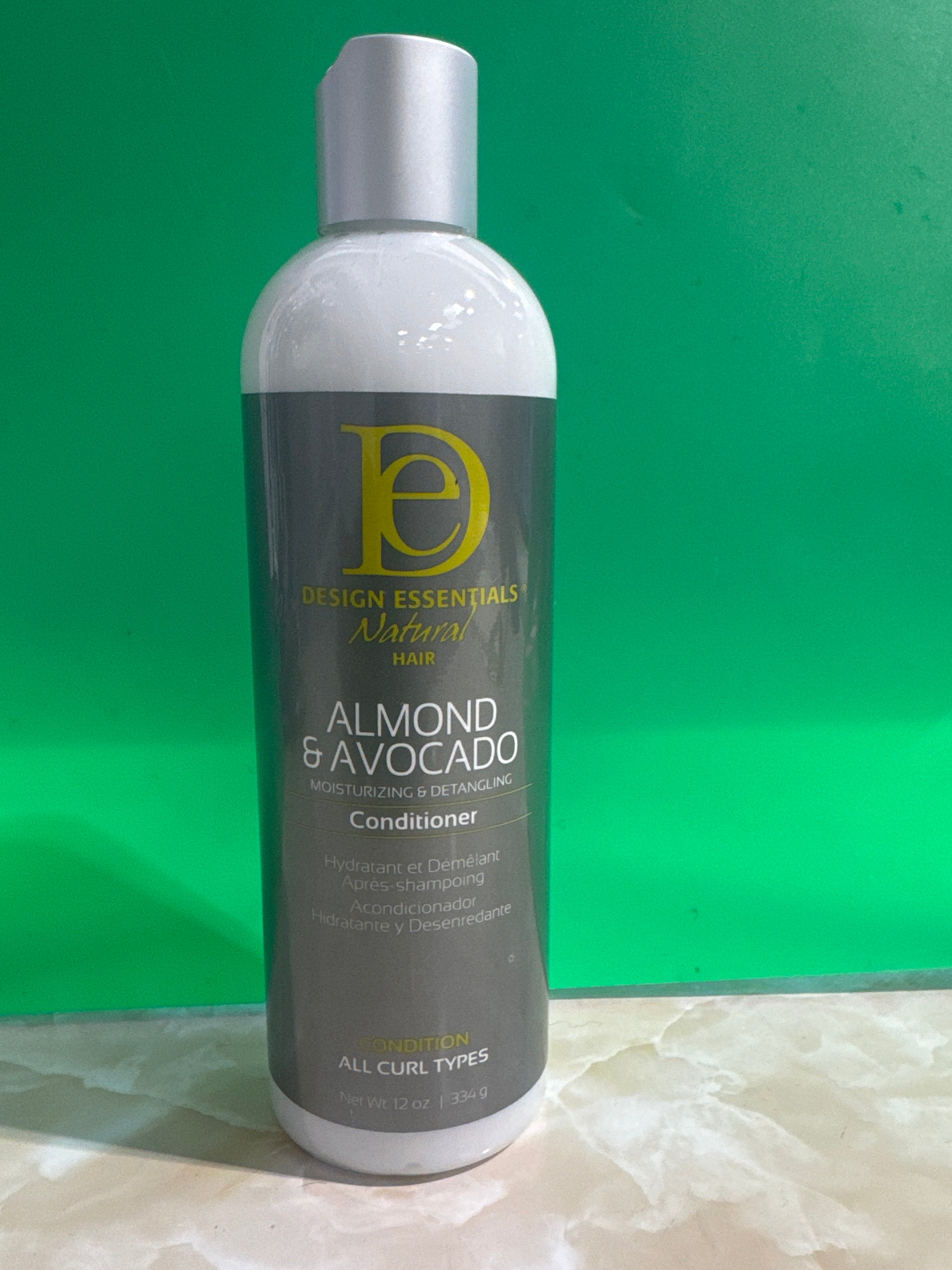 Moisturize and detangle with DESIGN ESSENTIALS ALMOND AND AVOCADO CONDITIONER for all curl types.